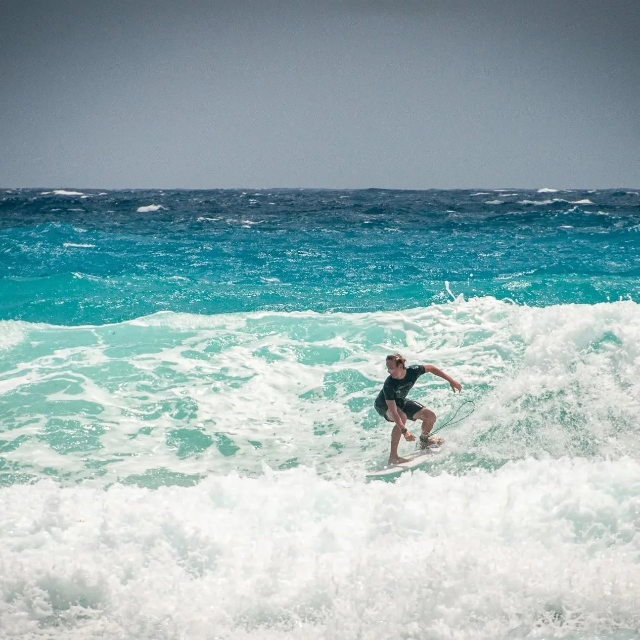 A surfer continuing technical progression at Playa Delfines.