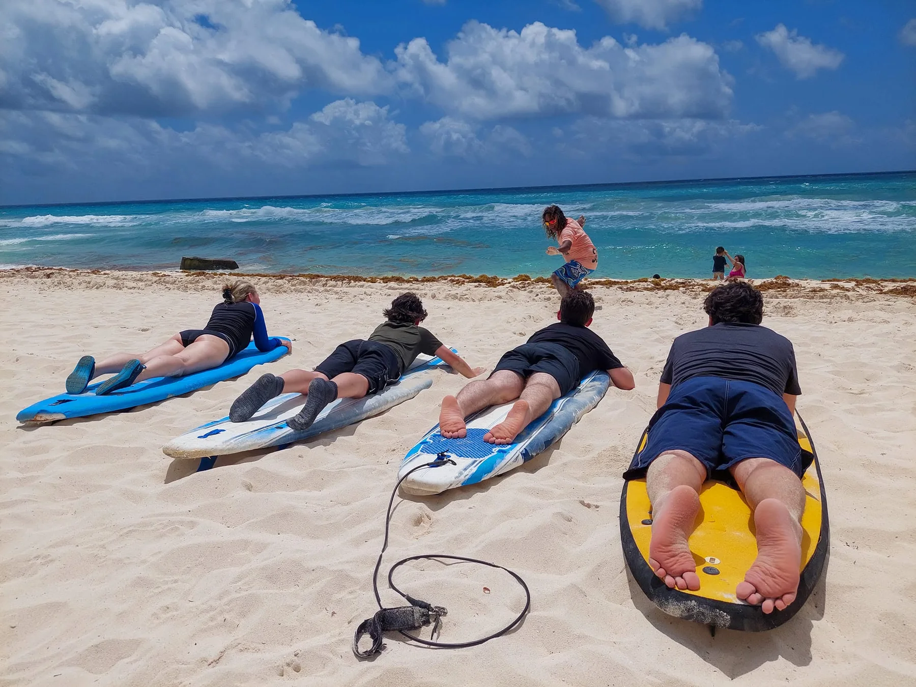 A group preparing on the sand before entering the ocean.